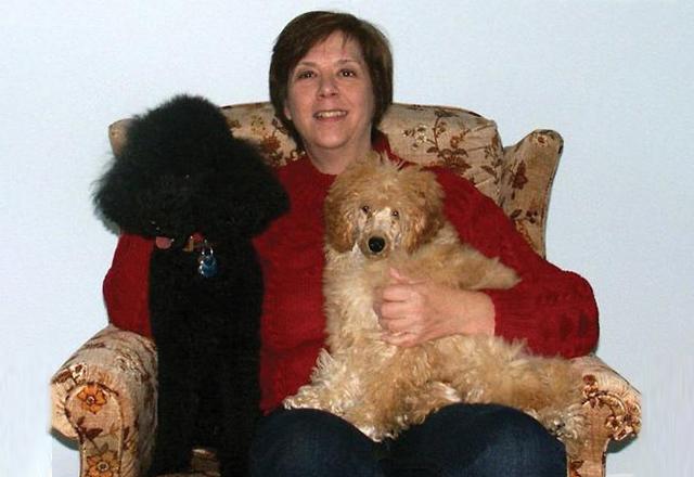 Leslie Pfenninger, pictured with poodles Justice and James